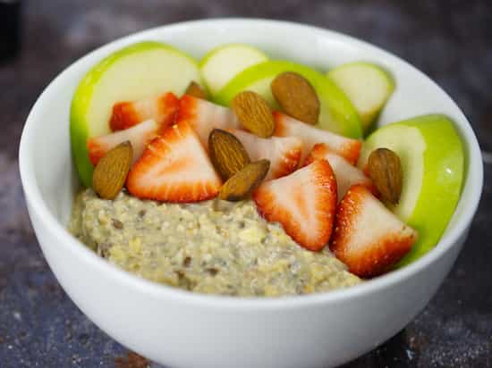 Bowl of Growli Muesli with added sliced apple, strawberries and almonds